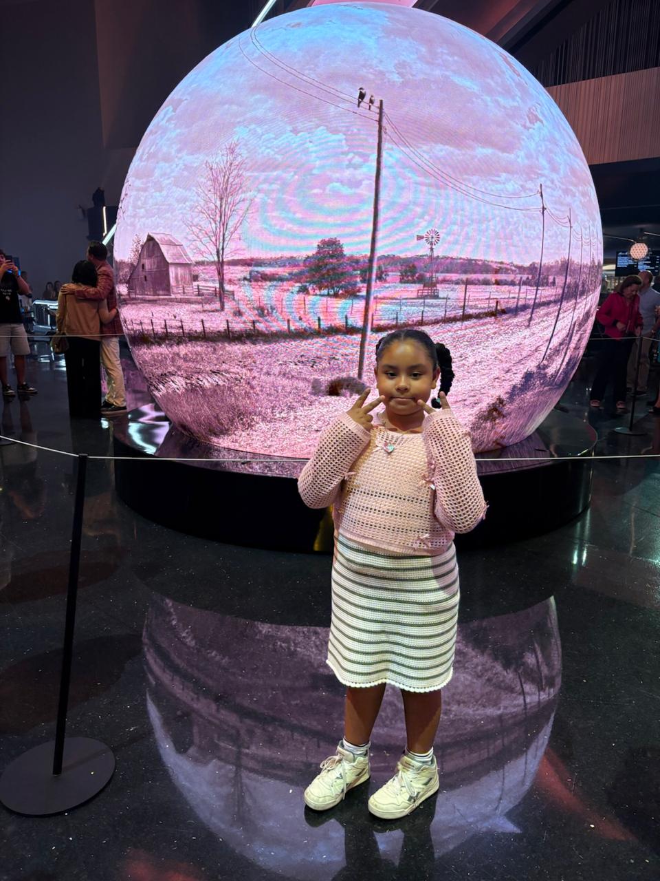Isabella at an immersive sphere exhibit